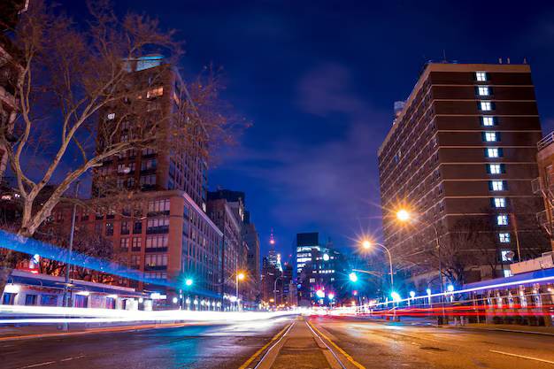 City skyline at night with illuminated buildings.